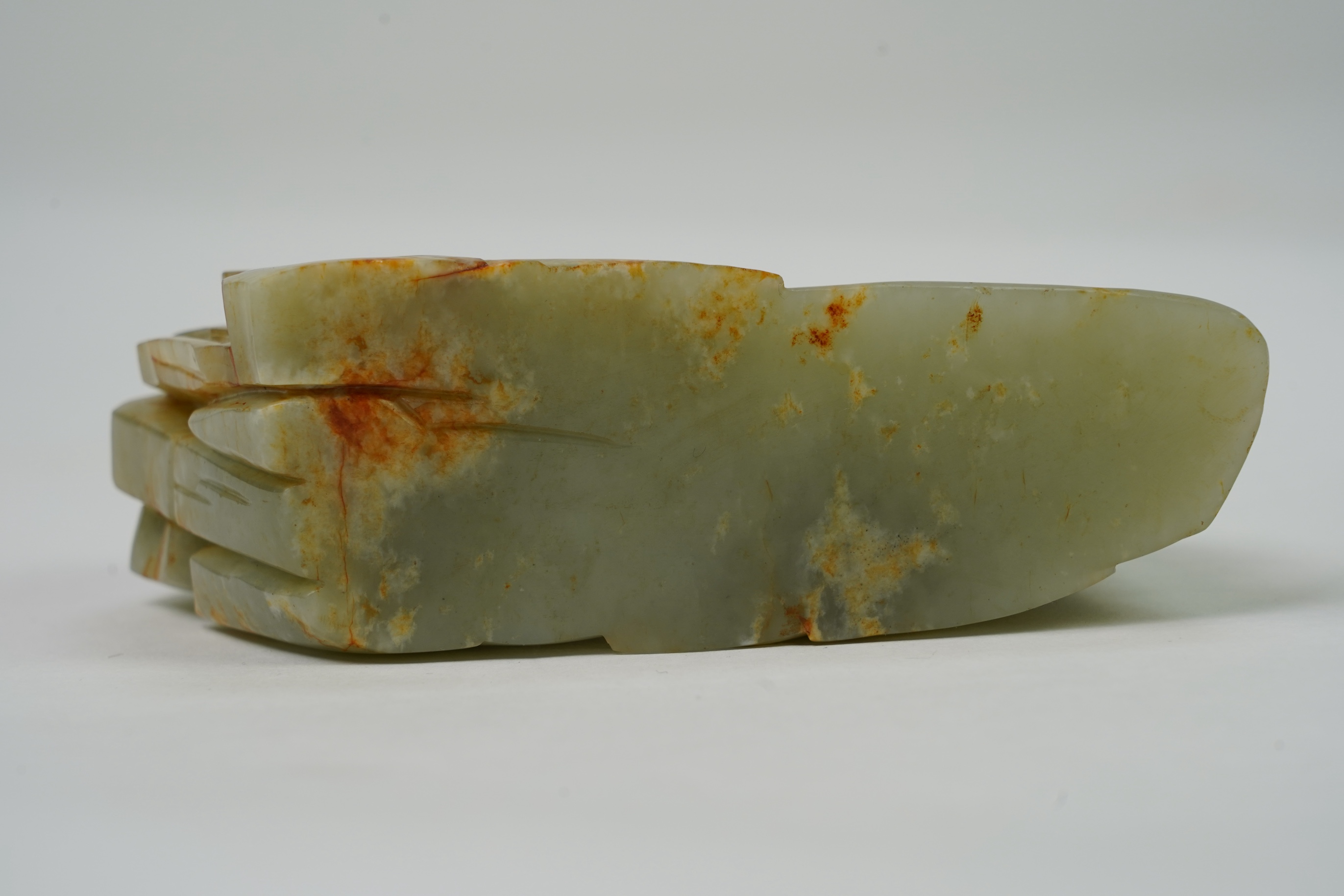 A Chinese celadon and russet jade boulder carving